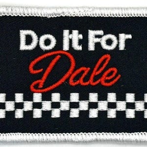 May include: Embroidered patch with the text "Do It For Dale" in white and red script on a black background. The patch has a checkered flag design at the bottom and a white border.