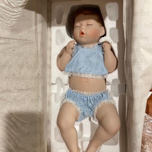 Porcelain baby doll “Good as Gold” by Ashton-Drake Galleries