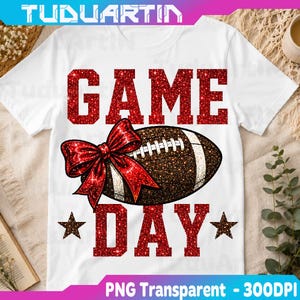 May include: A white t-shirt featuring the red glitter text GAME DAY with a brown glitter football graphic in the center. A large red glitter bow is attached to the football. Two brown glitter stars are positioned below the football graphic.
