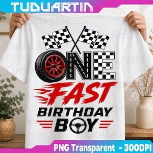 May include: A white t-shirt featuring a graphic design with two checkered flags, a black tyre with red rims, and the text ONE FAST BIRTHDAY BOY. The word ONE is stylised with a tyre and checkered pattern, while FAST is in red flame-like font.