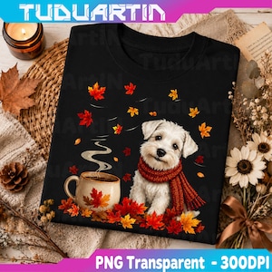 May include: A black t-shirt featuring a graphic of a white puppy wearing a red knit scarf, sitting next to a ceramic mug with steam rising, surrounded by scattered red and orange autumn maple leaves on a dark background.