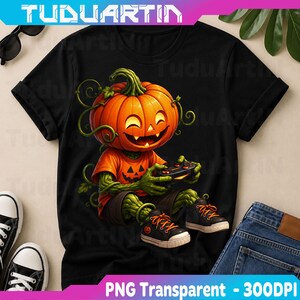 May include: A black t-shirt featuring a graphic of a pumpkin-headed character with green vine-like arms and legs. The character wears an orange shirt with a jack-o'-lantern face, dark shorts, and black trainers while holding a video game controller.