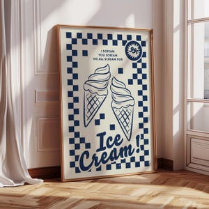 May include: A framed poster with a vintage ice cream theme. The poster features two ice cream cones and the words "I Scream You Scream We All Scream For Ice Cream!" in a navy blue font against a cream background with a navy blue checkerboard pattern.