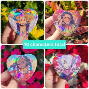 May include: Four heart-shaped holographic buttons with anime-style character illustrations. Each button features a different character with vibrant colors and designs. The text "10 characters total" is visible.