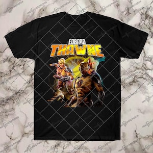 May include: Black t-shirt with a graphic of multiple versions of The Flash, including Eobard Thawne, with yellow lightning bolts and the text "Eobard Thawne".