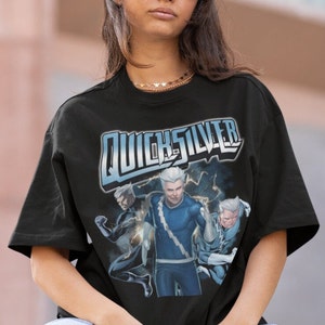 May include: Black t-shirt with a graphic print of Quicksilver from the Marvel comics. The graphic features Quicksilver in a blue and silver costume with lightning bolts.