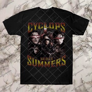 May include: Black t-shirt with a graphic of Cyclops from the X-Men comics. The graphic features a collage of Cyclops's face with the text "Cyclops Scott Summers" in red and yellow.