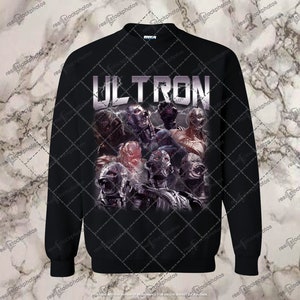 May include: Black sweatshirt with a graphic print of the Marvel character Ultron. The print features multiple versions of Ultron in a menacing pose. The text "ULTRON" is printed in white above the graphic.