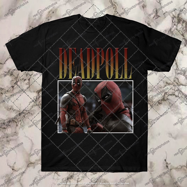 K&ouml;nnte beinhalten: Schwarzes T-Shirt mit einem Aufdruck von zwei Deadpool-Charakteren vor einem roten und gelben Hintergrund. Der Text "DEADPOOL" ist in gelben Buchstaben mit rotem Umriss gedruckt.