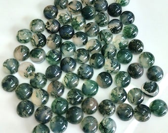 May include: A collection of 50 moss agate cabochons. The cabochons are round and have a smooth, polished surface. They are a mix of green, white, and brown colors.