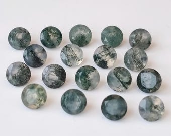 May include: A collection of 17 round, green moss agate gemstones. The stones are translucent and have a variety of green and white patterns.