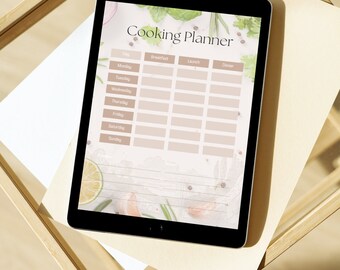 May include: A digital tablet displaying a weekly meal planner with a light brown background and a floral design. The planner is titled "Cooking Planner" and includes columns for "Day", "Breakfast", "Lunch", and "Dinner".