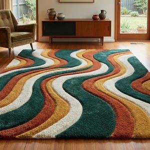 A high-quality Mid Century Modern hand tufted wool rug featuring a 3D abstract wave design in burnt orange, deep forest green, mustard yellow, and cream. The shag area rug has a plush multi-level pile and is styled on a wooden floor in a minimalist living room with vintage furniture.