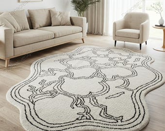 Alfombra de lana abstracta irregular artística: alfombra blanca y negra tejida a mano para un estilo moderno.
