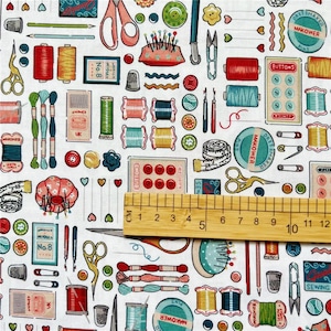 May include: White fabric with a repeating pattern of sewing and crafting supplies, including spools of thread, buttons, needles, scissors, thimbles, and measuring tape. The text "Dressmaker Pins", "Makower Pins", and "Buttons" are visible on the fabric.