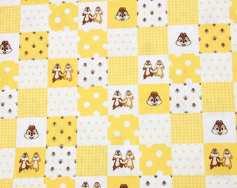 May include: Yellow fabric with a checkered pattern featuring cartoon chipmunks. The fabric has a white background with yellow squares and a variety of small polka dot patterns.