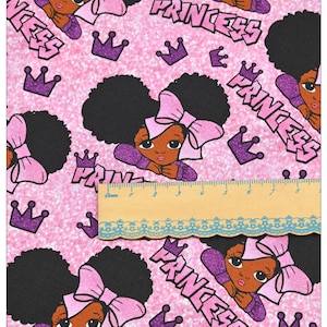 May include: Pink fabric with a repeating pattern of black girls with pink bows and the word "Princess" in purple letters. The background is a sparkly pink.