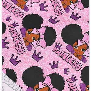 May include: Pink fabric with a repeating pattern of a black girl with an afro, a pink bow, and the word "Princess" in purple. The background is a sparkly pink.