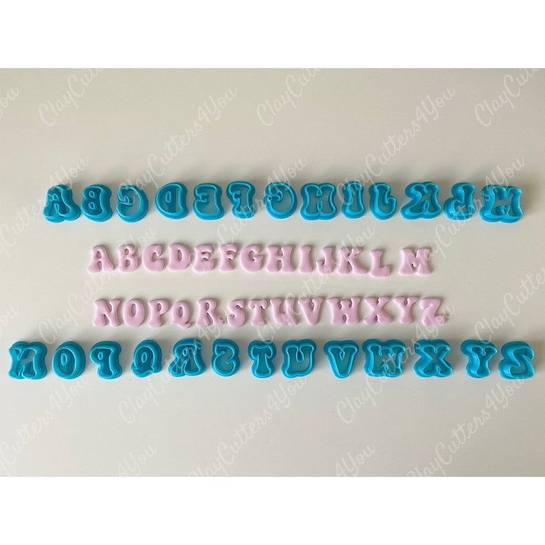 May include: A set of 26 alphabet cookie cutters, featuring both uppercase and lowercase letters. The uppercase letters are pink and the lowercase letters are blue.