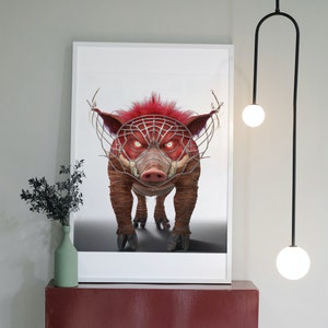 May include: A framed print of a red boar with a metal cage over its face. The boar is looking directly at the viewer with an angry expression. The print is hanging on a wall above a red shelf.