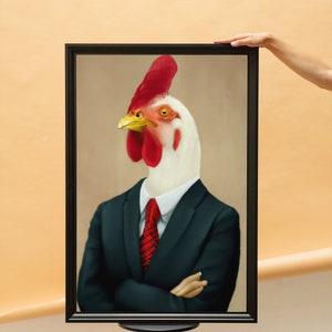 May include: Framed artwork featuring a rooster in a black suit with a red tie. The rooster has a white head, red comb, and yellow beak. The artwork is displayed on a black tripod stand against a neutral background.