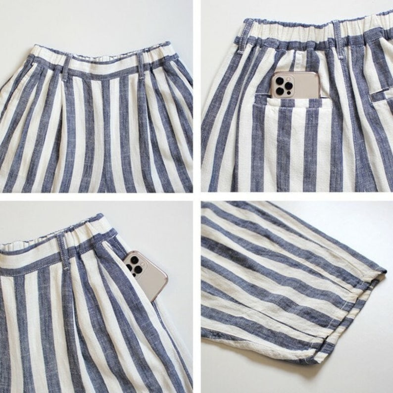 May include: Close-up shots of blue and white striped shorts. The shorts have a comfortable elastic waistband and pockets. A smartphone is visible in one of the pockets. The fabric appears to be a lightweight linen or cotton blend.