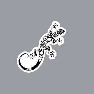 May include: A black and white sticker featuring a stylised lizard graphic. The lizard is depicted with intricate, flowing tribal-inspired patterns throughout its body, limbs, and long, curved tail, all outlined with a clean white border.