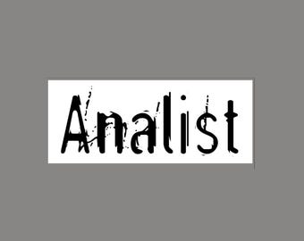 May include: A rectangular white sticker featuring the word Analist in a black, distressed, ink-splattered font. The letters have a rough, textured appearance with vertical streaks and irregular edges, creating a bold, high-contrast graphic design.