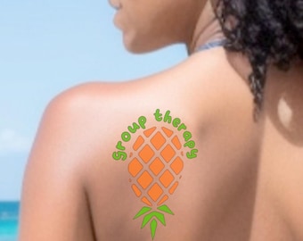 May include: A temporary tattoo featuring an orange pineapple graphic with a diamond-patterned texture and green leaves at the base. The text "Group therapy" is written in a green, rounded font, arching over the top of the pineapple design.