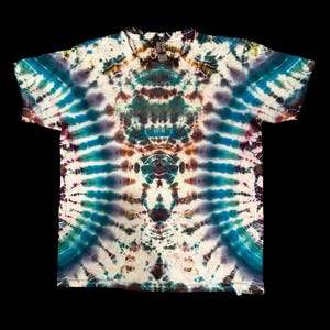 May include: A tie-dye t-shirt with a white background and a symmetrical pattern of blue, purple, green, and brown colors.