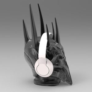 May include: A black and gray crown with a white pair of headphones on it. The crown is a replica of the Iron Throne from the Game of Thrones television series.