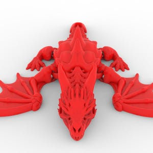 May include: A red dragon figurine with outstretched wings, detailed with sharp spines and a skeletal structure. The dragon is lying on a white surface, showcasing its intricate design and menacing features. The wings are spread wide, ready for flight.