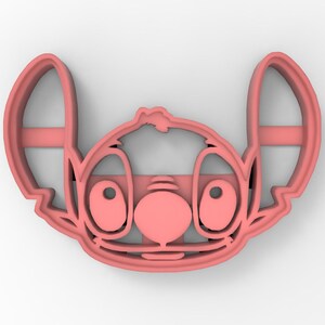 May include: Pink plastic cookie cutter shaped like Stitch from the Disney movie Lilo & Stitch. The cutter features Stitch's signature blue fur, big eyes, and a wide smile.