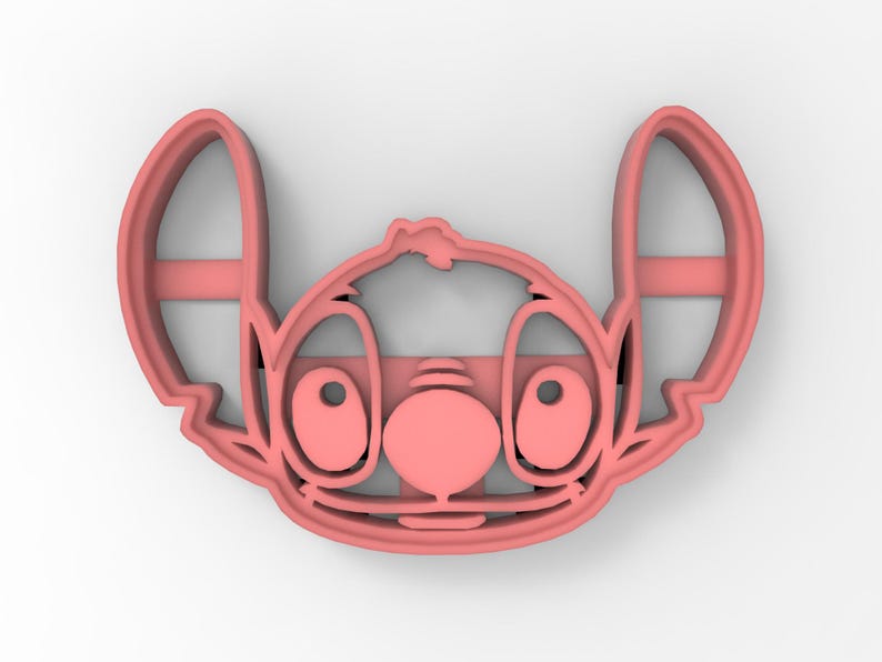 May include: Pink plastic cookie cutter shaped like Stitch from the Disney movie Lilo & Stitch. The cutter features Stitch's signature blue fur, big eyes, and a wide smile.