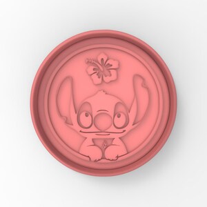 May include: Pink plastic cookie cutter shaped like Stitch from Lilo & Stitch, with a hibiscus flower above him.
