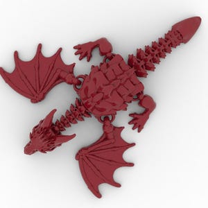 May include: A red dragon figurine with articulated joints, wings, and a detailed skeletal structure. The dragon is depicted in a top-down view, showcasing its intricate design and overall shape. The wings are spread, and the tail is pointed.