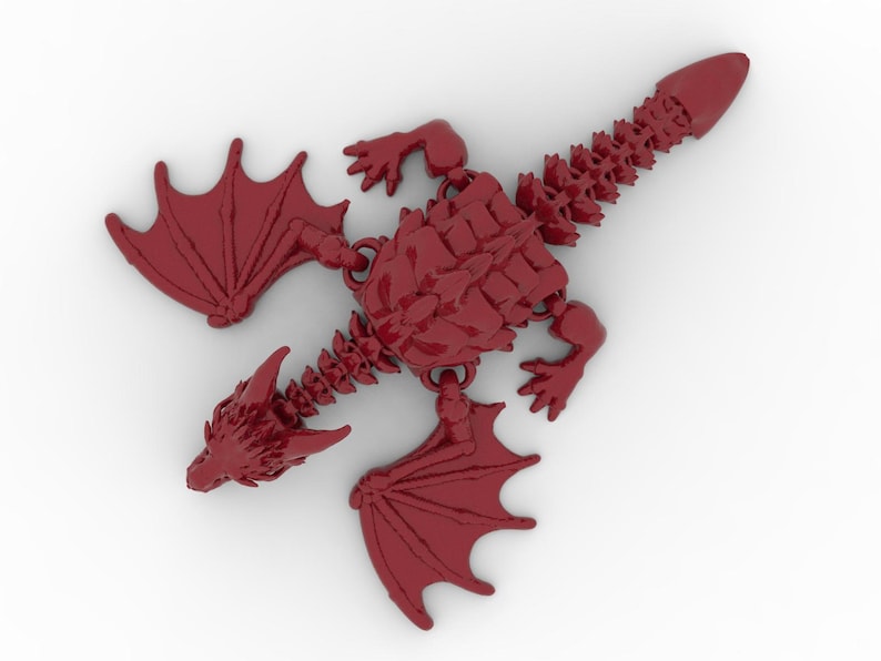 May include: A red dragon figurine with articulated joints, wings, and a detailed skeletal structure. The dragon is depicted in a top-down view, showcasing its intricate design and overall shape. The wings are spread, and the tail is pointed.