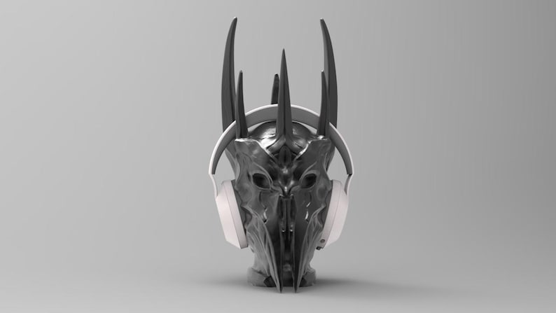 May include: A black and silver crown with horns, wearing white headphones.