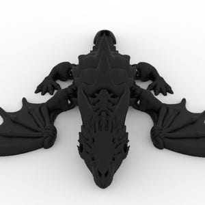 May include: A black dragon figurine with outstretched wings, claws, and a detailed head. The dragon is lying flat, showcasing its intricate design. The figurine is a solid, dark color, and appears to be made of a hard material.