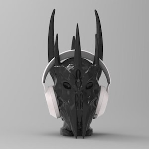 May include: A black and gray helmet with horns, wearing white headphones. The helmet has a detailed design with a face-like structure.