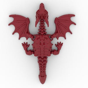 May include: A detailed, top-down view of a red dragon figurine. The dragon has outstretched wings, four legs, and a long tail. The figurine is a solid, three-dimensional object with intricate details.