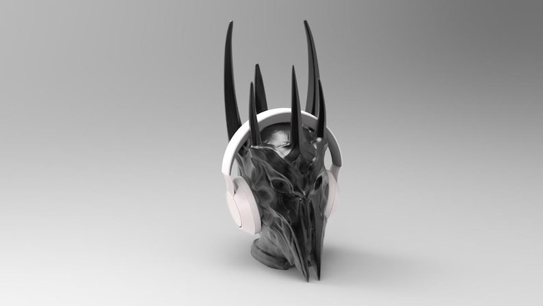 May include: A black and white sculpture of a head wearing white headphones. The sculpture has a crown of sharp points.