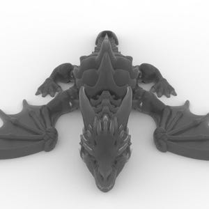 May include: A dark gray dragon figurine with outstretched wings, detailed scales, and a spiked spine. The dragon is lying flat, showcasing its intricate design. The wings are spread wide, and the head is facing forward.