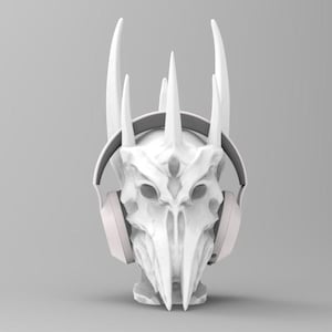 May include: White 3D printed skull with horns wearing white headphones. The skull has a detailed design with sharp edges and a pointed chin.