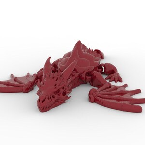 May include: A maroon-colored dragon figurine with detailed wings, claws, and a spiky spine. The dragon is lying down, with its wings spread out to the sides. The figurine is a fantasy-themed collectible.