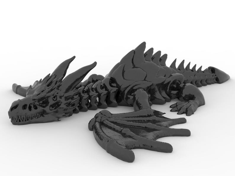 May include: A black dragon figurine with detailed skeletal features, wings, and a long tail. The dragon is lying down on a white surface, showcasing its intricate design and texture. This fantasy-themed sculpture is a decorative item.