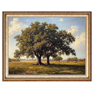 May include: A framed oil painting depicting a landscape with two large oak trees in the foreground. The trees have lush green foliage and are set against a backdrop of a blue sky with white clouds. The painting is framed in a gold-colored frame.