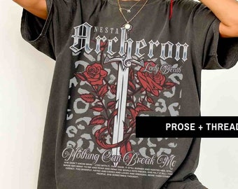May include: A dark gray oversized t-shirt with a graphic print of a sword and roses. The text "Archeron Lady Death" and "Nothing Can Break Me" are printed on the shirt.