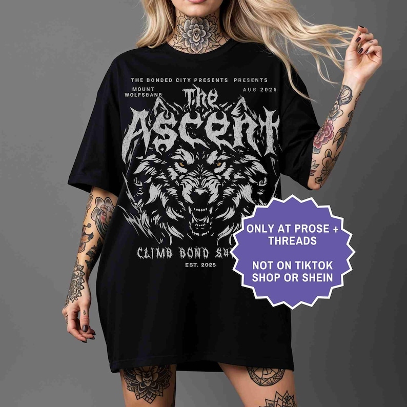 May include: Black t-shirt featuring a detailed wolf graphic with the text "The Ascent" and event details. The shirt also includes the text "Climb Bond Su" and "Est. 2025". Additional text on the shirt reads "Only at Prose + Threads" and "Not on TikTok Shop or Shein."