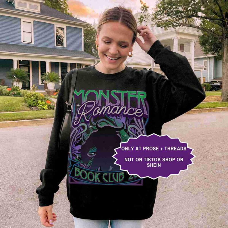 May include: Black sweatshirt with the text "MONSTER Romance BOOK CLUB" in green and purple. The design includes a silhouette of a monster. A purple banner reads "ONLY AT PROSE + THREADS NOT ON TIKTOK SHOP OR SHEIN".